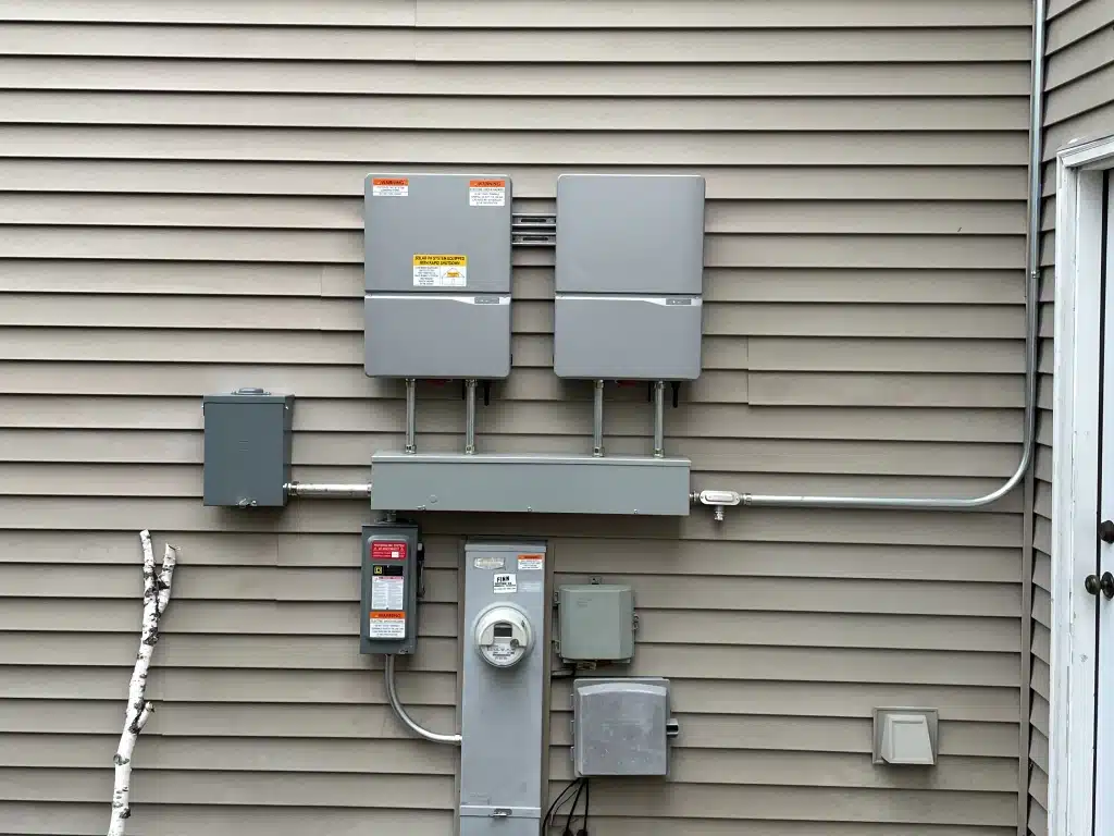 Wide view of Delta inverter and BOS equipment mounted on a wall